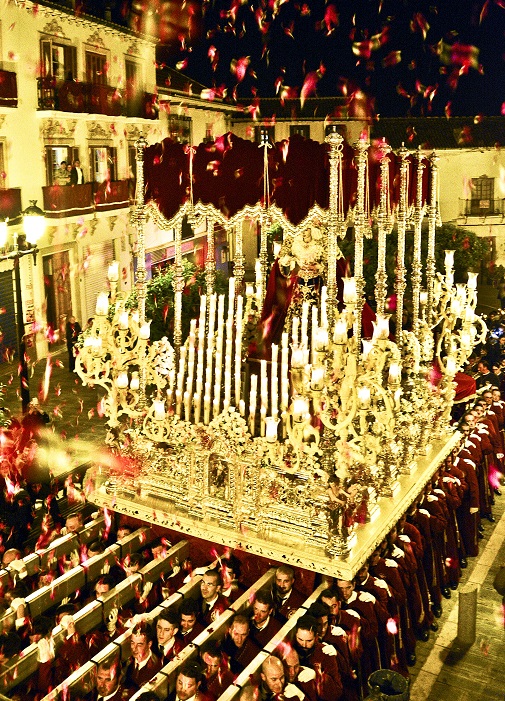 Semana Santa with People throwing rose petals from the balcony